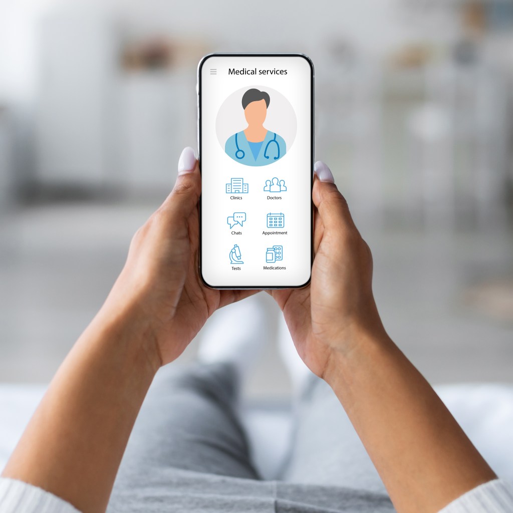 Woman laying on bed with mobile phone, using medical app